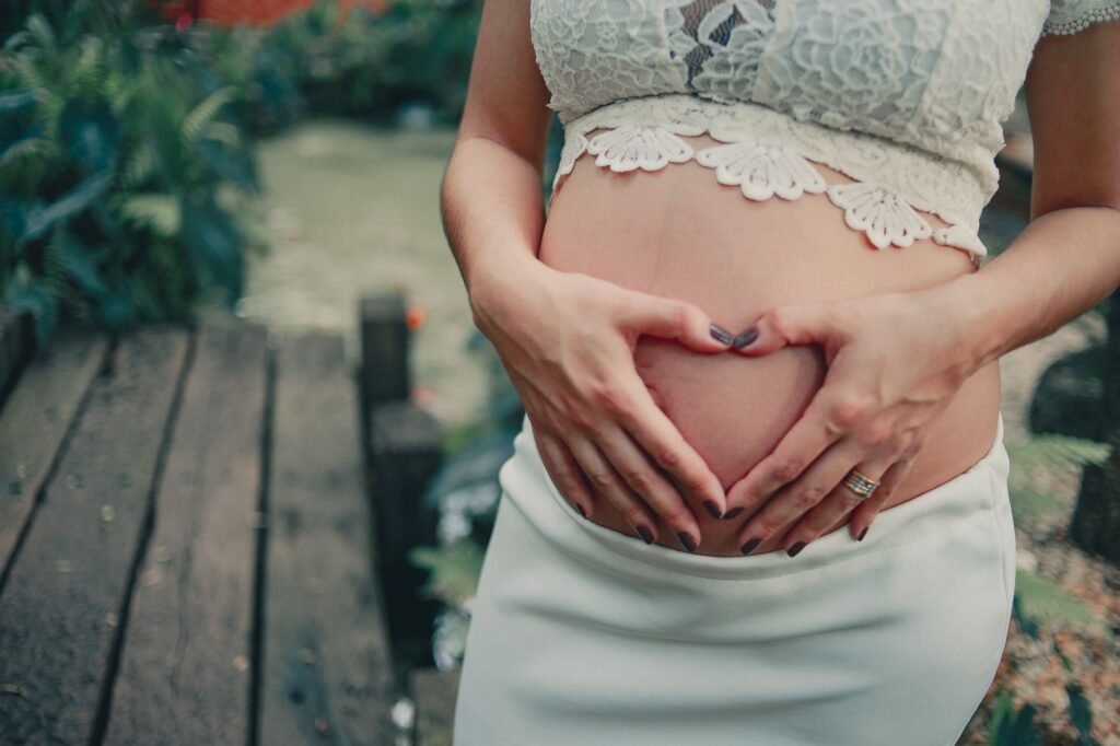 Pregnant woman praying Uplifting Prayers for a Difficult Pregnancy