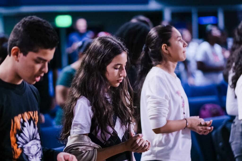 Young people praying How to Pray for Spiritual Fruit