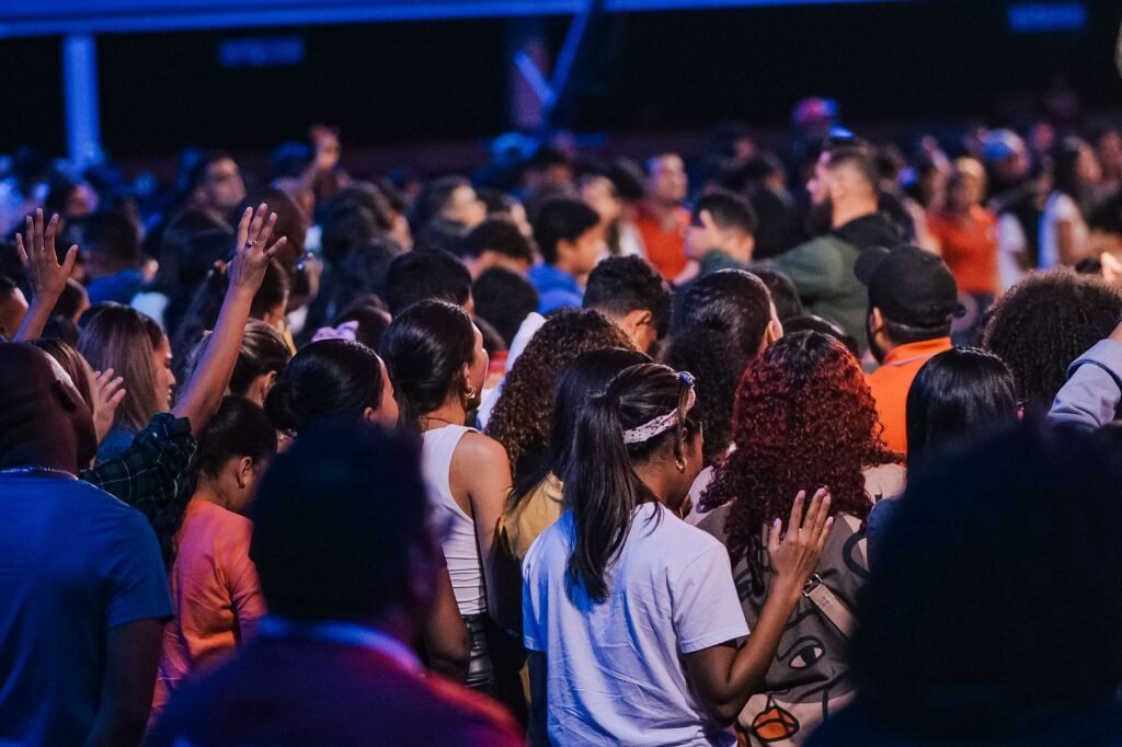 A diverse group of people gathered in prayer and worship, embodying the spirit of humility