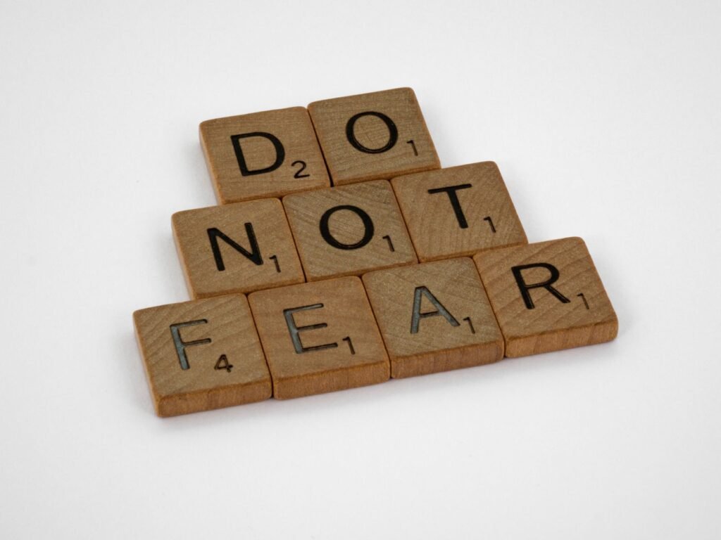 A person standing on a cliff, symbolizing facing fears and stepping into faith
