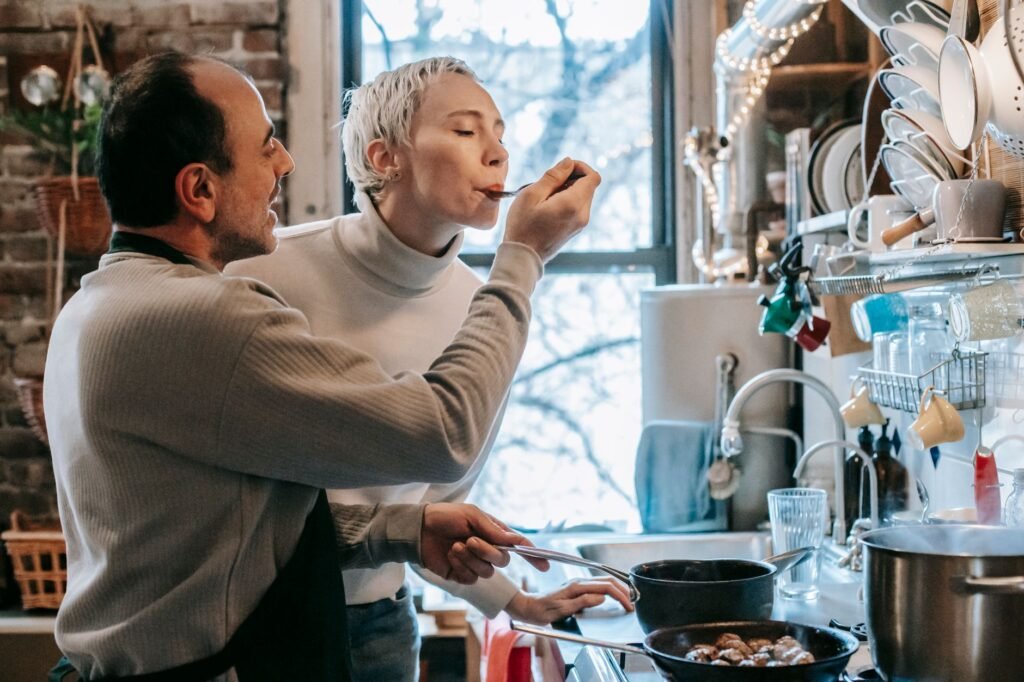 A couple cooking together, demonstrating love and teamwork in their daily lives