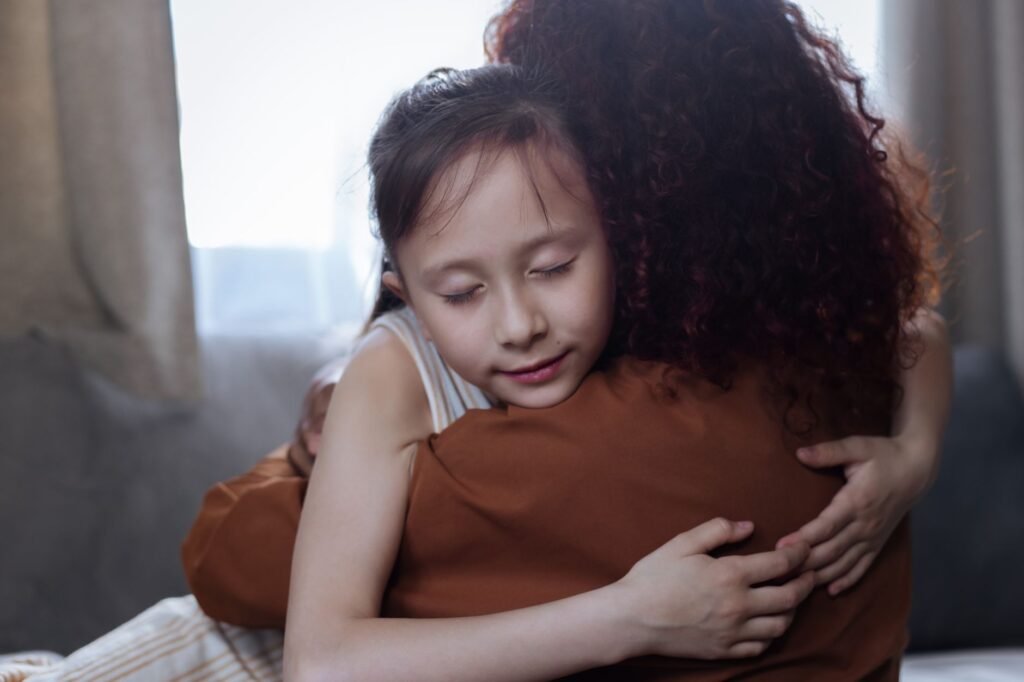 A parent comforting a child, illustrating the importance of support and prayer during difficult times