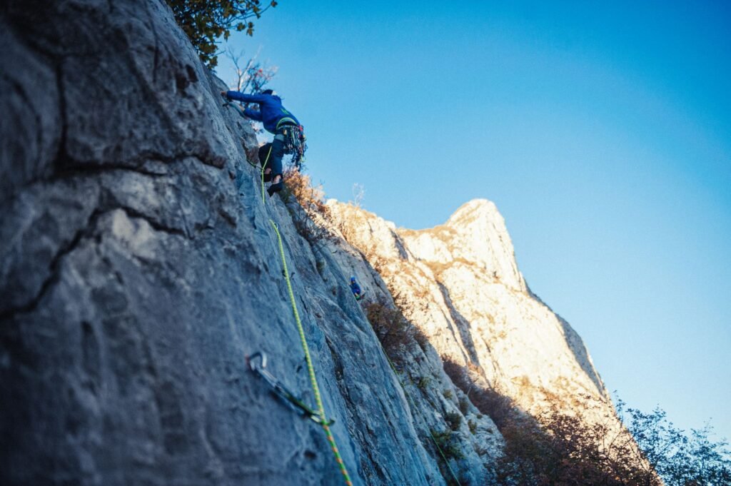 A person climbing a mountain, symbolizing the journey through challenges