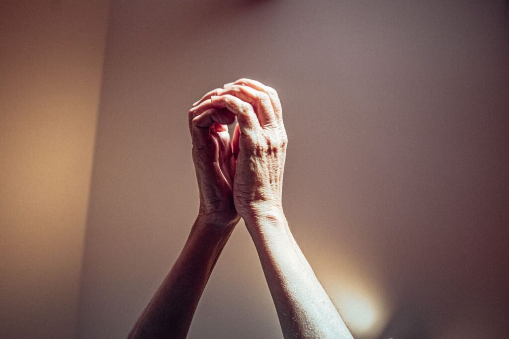 A person in prayer, seeking God's guidance for patience