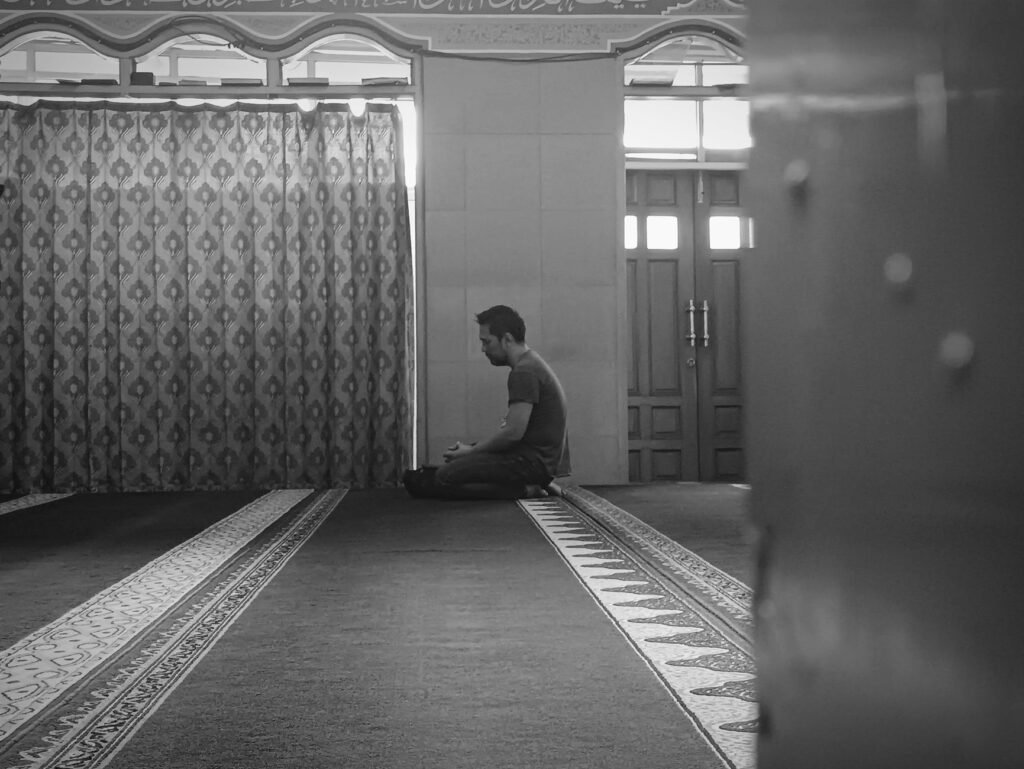 A person kneeling in prayer, seeking comfort and guidance from God