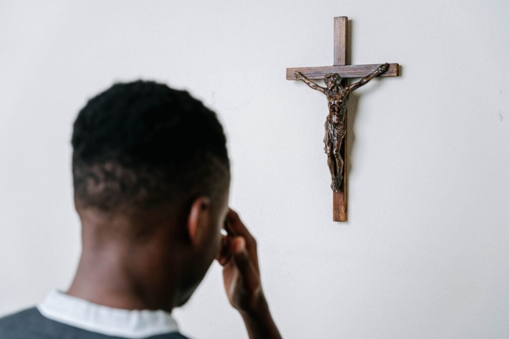 A person praying in quiet contemplation, seeking God during uncertain times