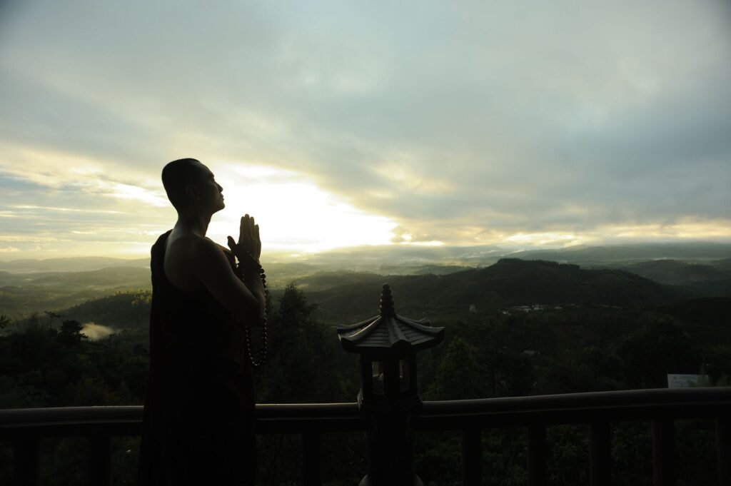 A person praying outdoors, reflecting on spiritual discernment