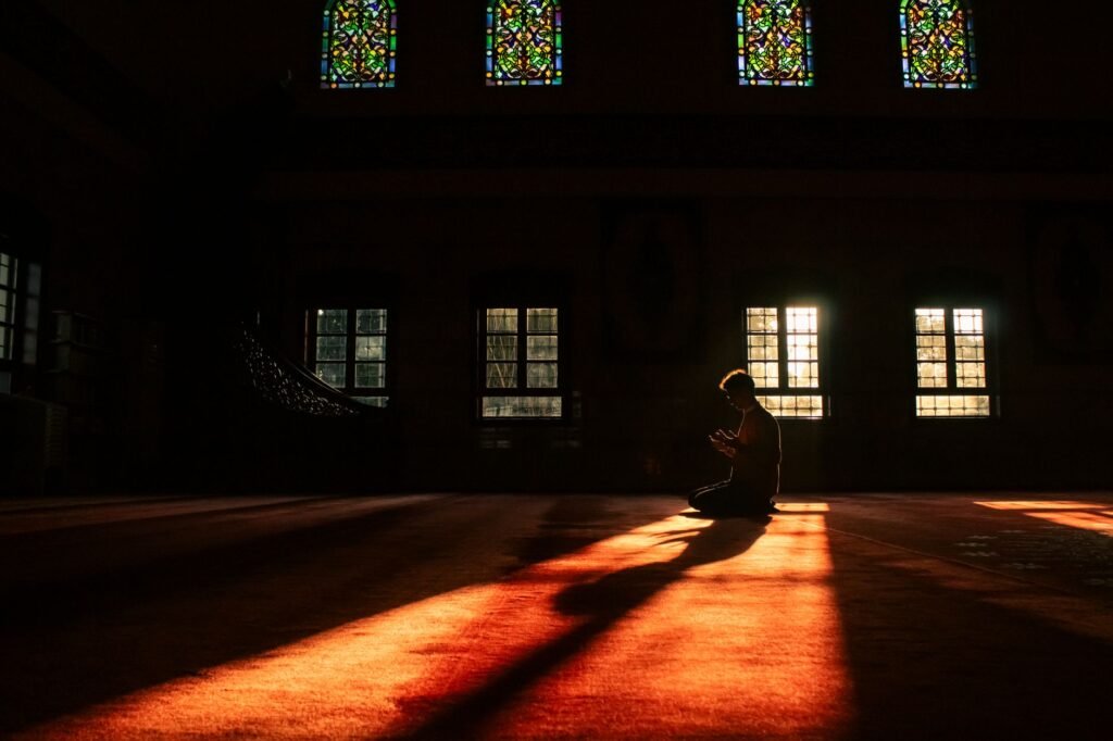 A person praying quietly, reflecting on their personal relationship with God