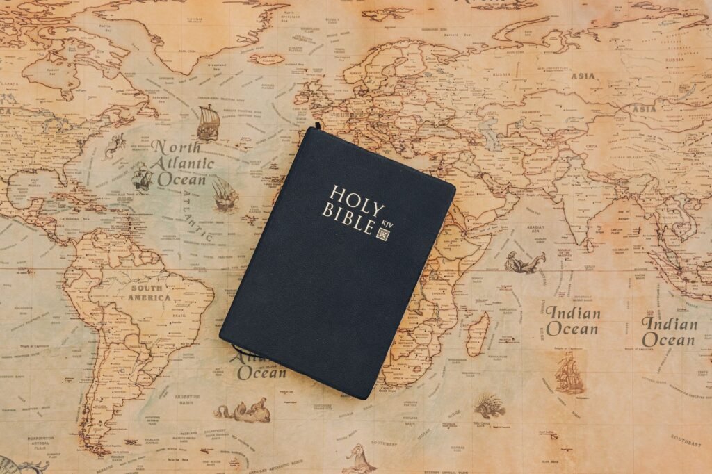 A person praying with an open Bible, symbolizing faith
