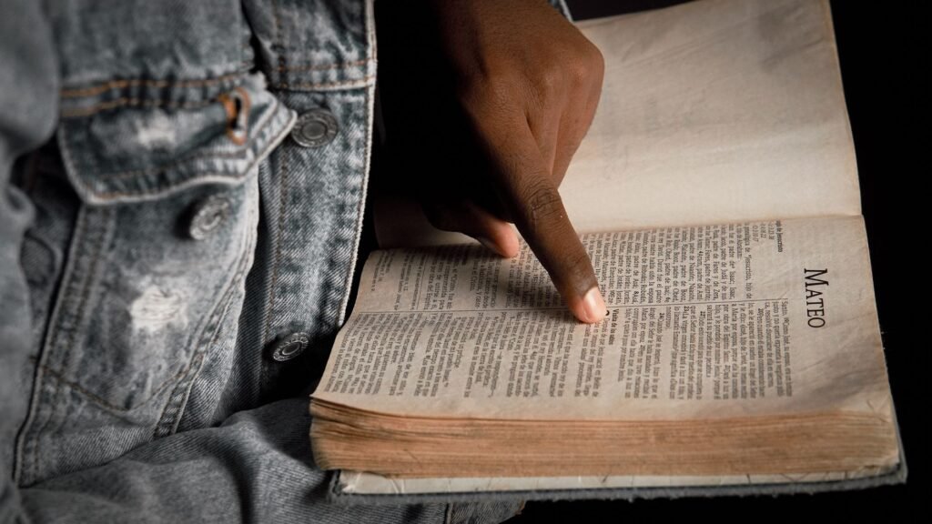 A person reading the Bible, finding comfort in God's promises