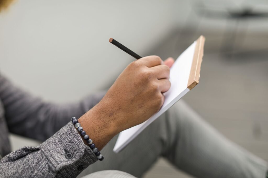 A person reflecting on scripture while journaling