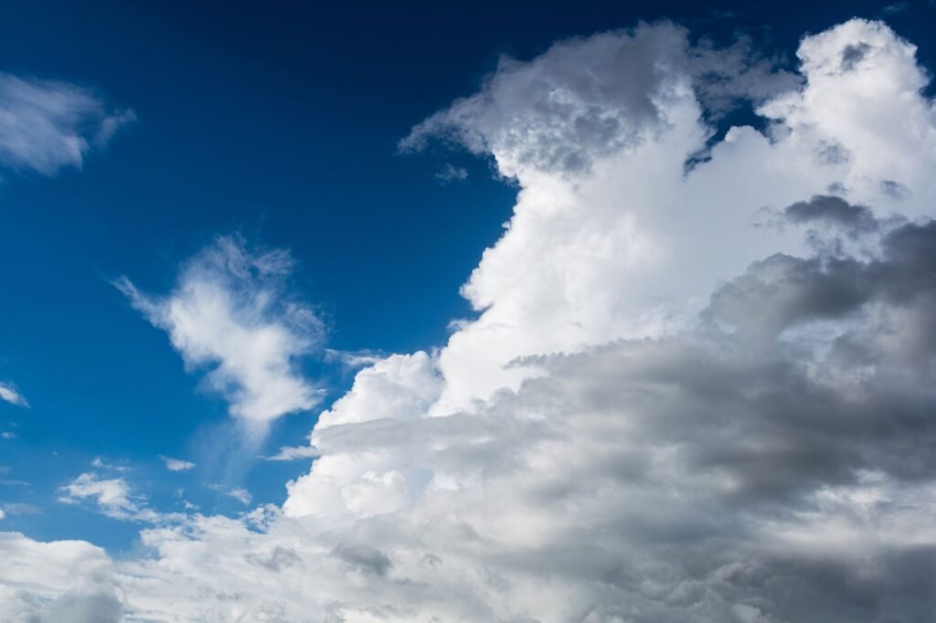A silhouette of a person looking towards cloudy skies symbolizes uncertainty